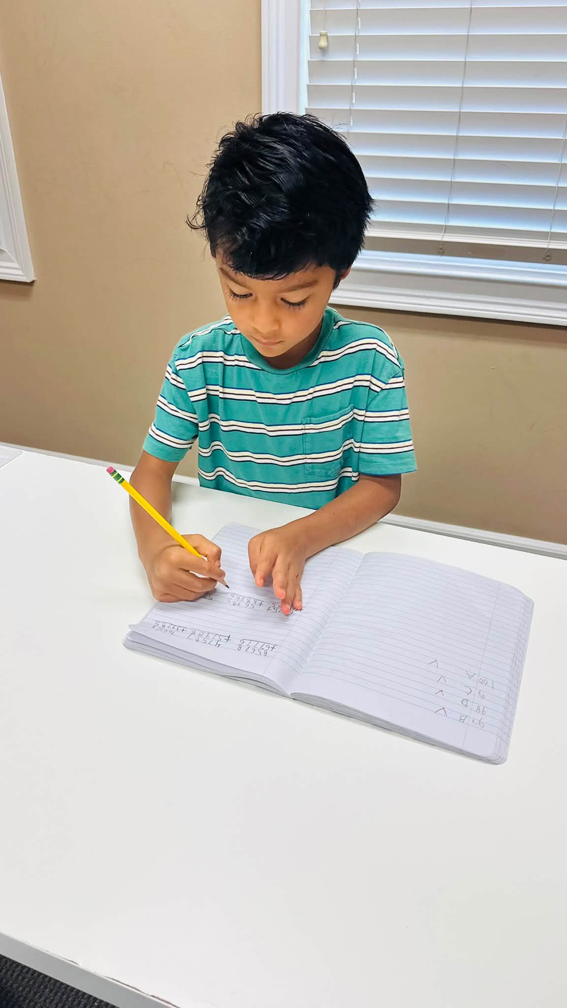 Student doing math practice at a table